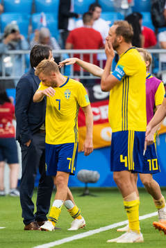 Sebastian Larsson and Andreas Granqvist of Sweden looks