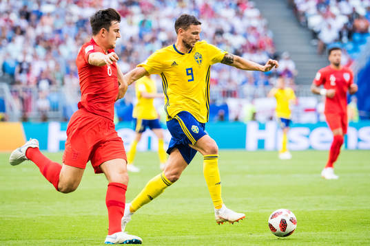Marcus Berg of Sweden and Jordan Henderson of England