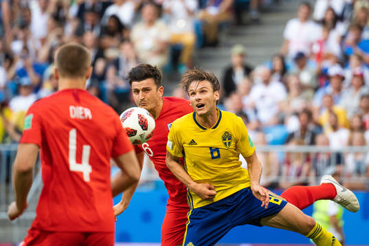 Harry Maguire of England and Albin Ekdal of Sweden competes