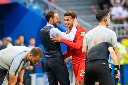 head coach Gareth Southgate celebrates with Dele Alli as he