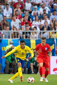 Martin Olsson of Sweden and Kieran Trippier of England