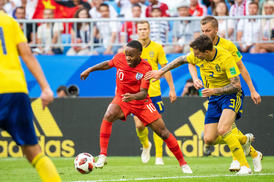Raheem Sterling of England and Victor Nilsson Lindelöf of
