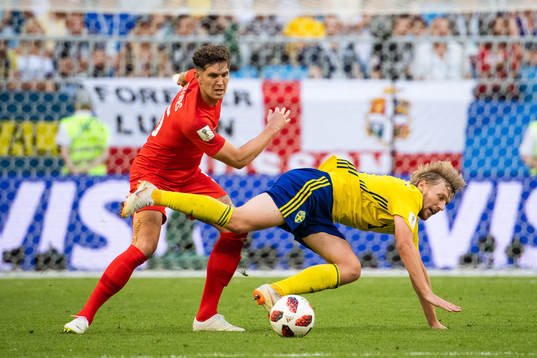 John Stones of England and Emil Forsberg competes for the