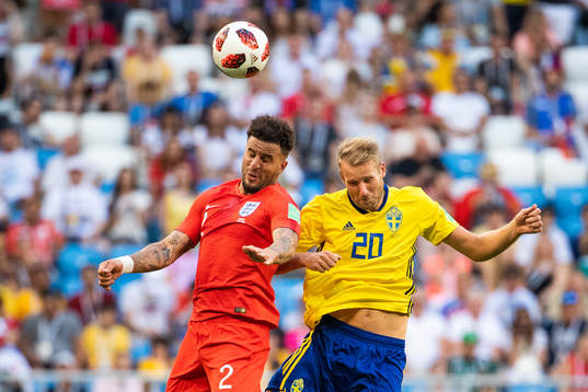 Kyle Walker of England competes for the ball with Ola