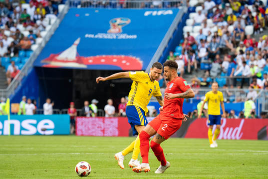 Marcus Berg of Sweden and Kyle Walker of England competes