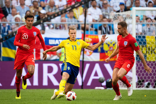 Dele Alli and Jordan Henderson competes for the ball with