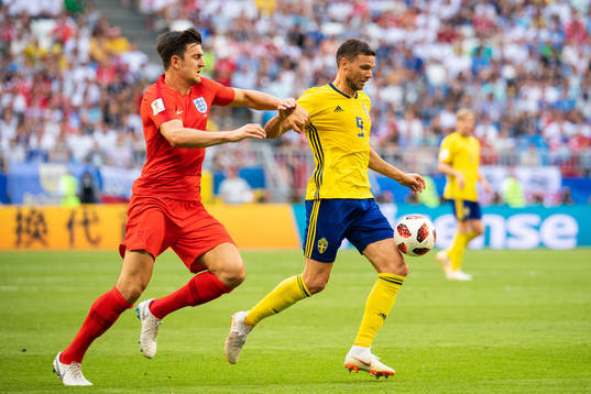 Harry Maguire of England and Marcus Berg of Sweden