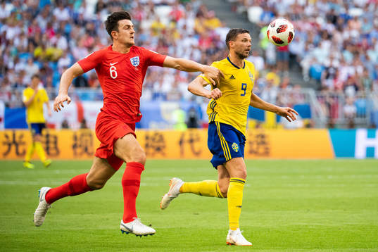 Harry Maguire of England and Marcus Berg of Sweden