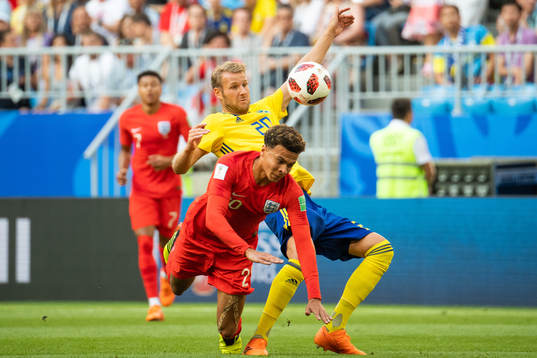 Dele Alli of England and Ola Toivonen of Sweden