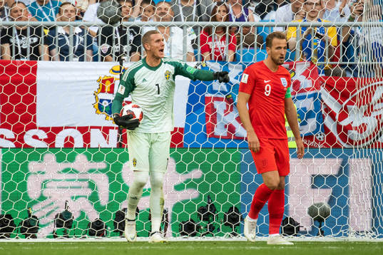 Goalkeeper Robin Olsen of Sweden and Harry Kane of England