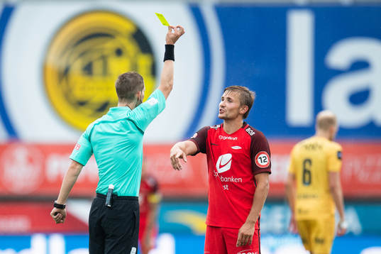Espen Andreas Eskås, referee, gives a yellow card to