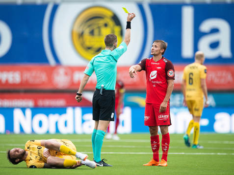 Espen Andreas Eskås, referee, gives a yellow card to