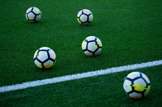 Fotbollar på en konstgräsplan