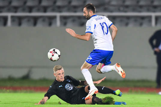 Sören Rieks of Malmö FF slide tackles Xhevdet Shabani of