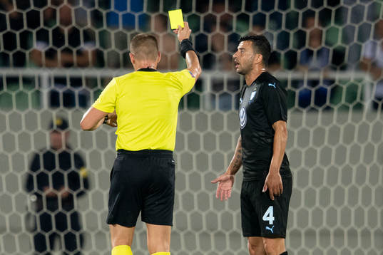 Behrang Safari of Malmö FF gets a yellow card