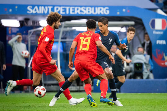 Moussa Dembele and Marouane Fellaini of Belgium competes