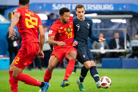 Moussa Dembele of Belgium competes for the ball with