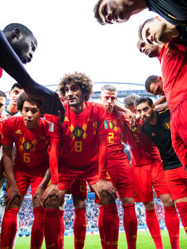 Romelu Lukaku talks to team mates Axel Witsel, Marouane