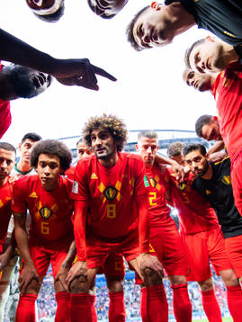 Romelu Lukaku talks to team mates Axel Witsel, Marouane