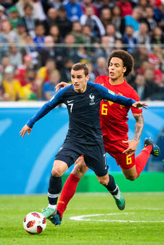 Antoine Griezmann of France competes for the ball with Axel