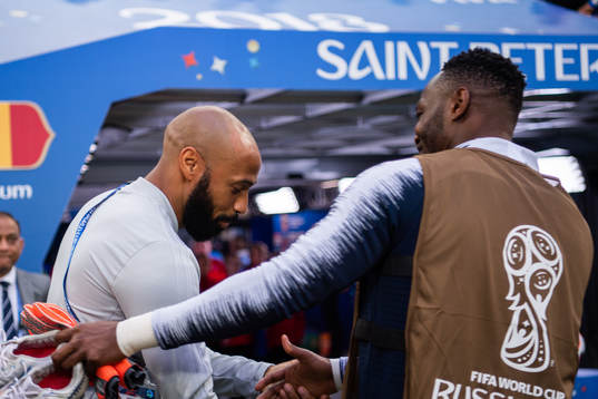 Assisting coach Thierry Henry of Belgium hugs a french