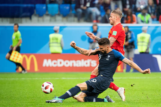 Olivier Giroud of France competes for the ball with Toby