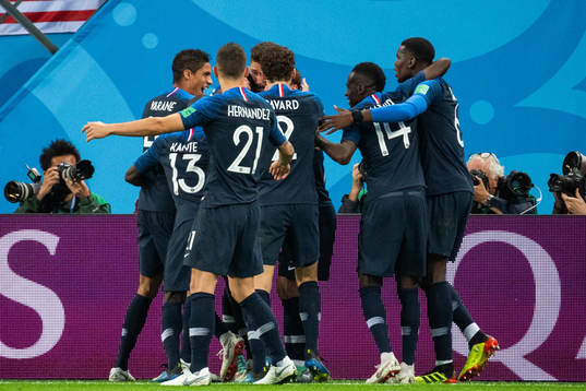 Samuel Umtiti celebrates swith team mates Raphael Varane