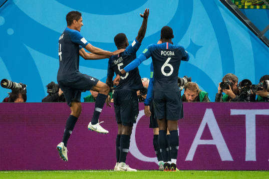 Samuel Umtiti celebrates swith team mates Raphael Varane