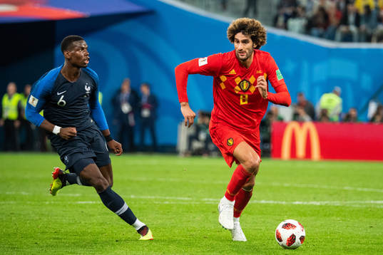 Paul Pogba of France chases Marouane Fellaini of Belgium