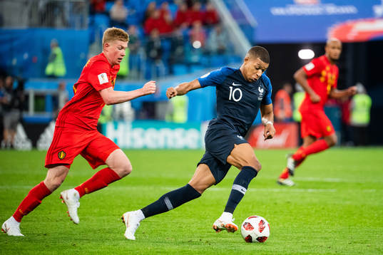 Kevin De Bruyne of Belgium chases Kylian Mbappe of France