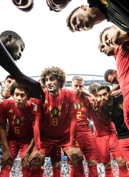 Romelu Lukaku talks to team mates Axel Witsel and Marouane