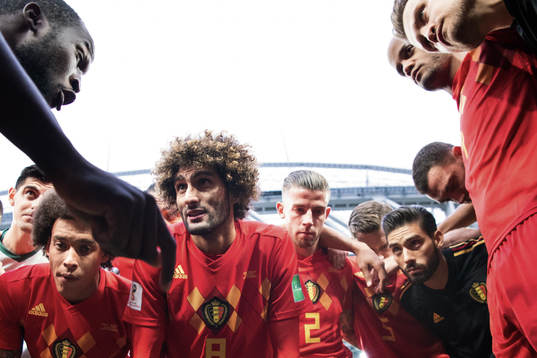 Romelu Lukaku talks to team mates Axel Witsel, Marouane