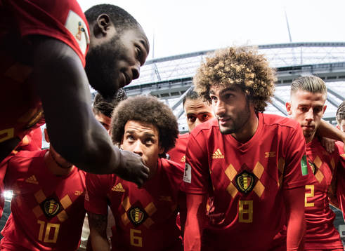 Romelu Lukaku talks to team mates Axel Witsel and Marouane