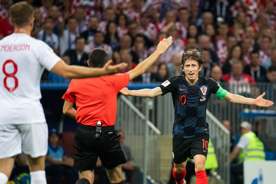 Luka Modric of Croatia react toward referee Cuneyt Cakir