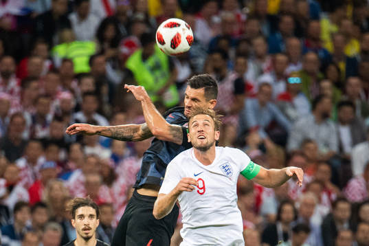 Dejan Lovren of Croatia and Harry Kane of England competes