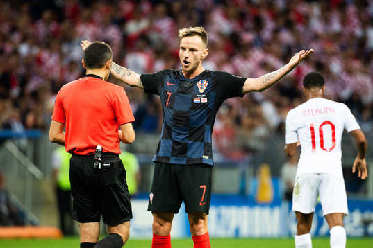 Ivan Rakitic of Croatia in a discussion with referee Cuneyt
