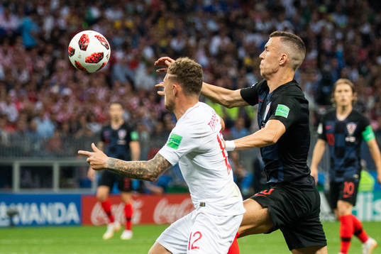 Kieran Trippier of England competes for the ball with Ivan