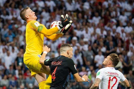 goalkeeper Jordan Pickford of England competes for the ball