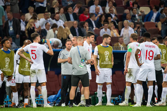 Players of England gather in wait for extra time