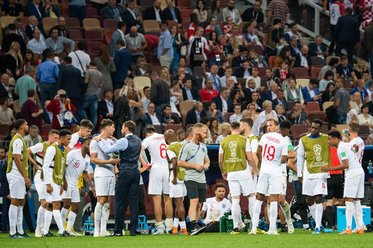 Players of England gather in wait for extra time