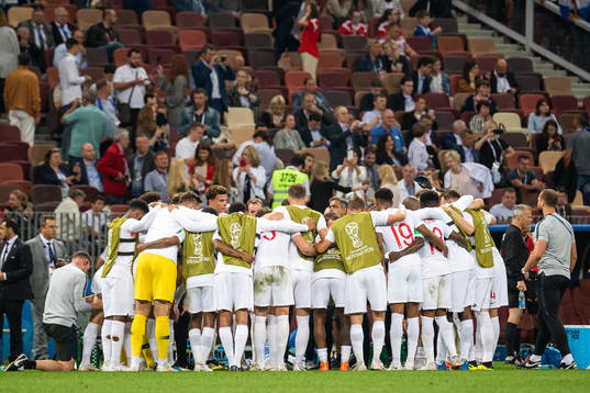 Players of England gather in wait for extra time