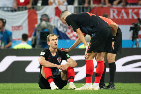 Ivan Perisic talks to Ivan Strinic of Croatia who sits down