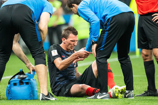 Mario Mandzukic sits getting medical attention
