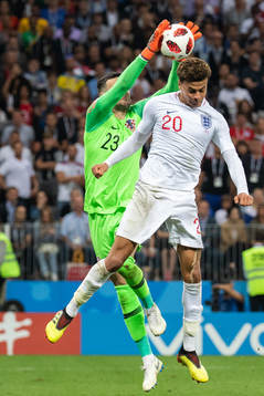 Dele Alli of England and goalkeeper Danijel Subasic of