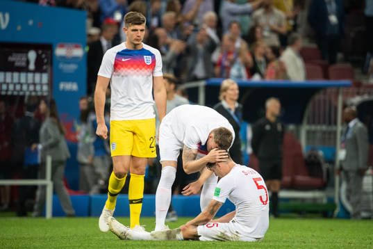 John Stones of England sits down looking dejected