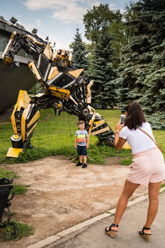 People outside a transformers museum Muzey Vosstaniya Mashin