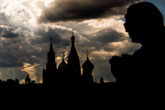 People walk by the Saint Basil's Cathedral