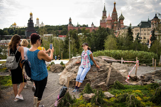 People take pictures with the Saint Basil's Cathedral in