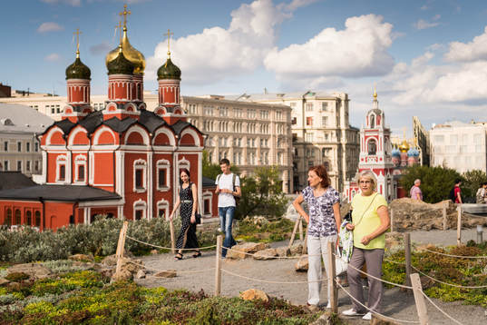 People are seen walking in a park in central Moscow