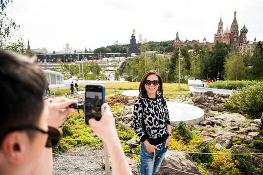 People take pictures with the Saint Basil's Cathedral in